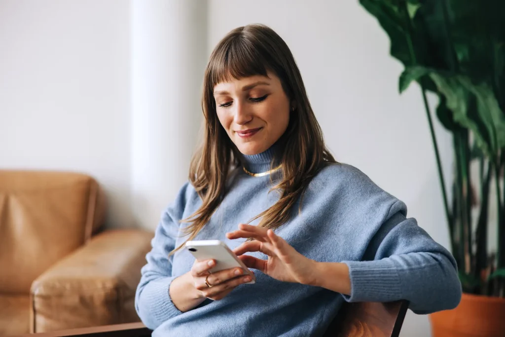woman using a mobile phone in an office lobby